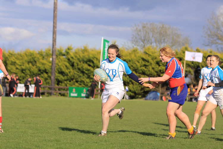 Female Rugby Player Breaking a Tackle